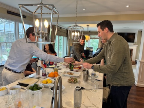 Wedding reception guests being served by a bartender
